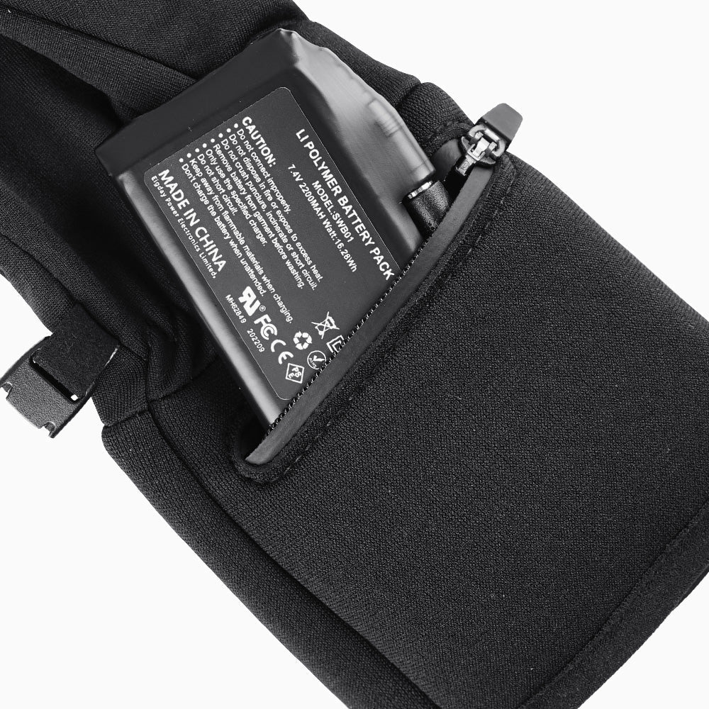A battery slipping into the cuff pocket of a heated glove.