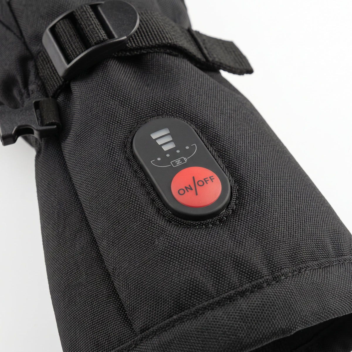 The heat button and level lights on the cuff of a heated glove.